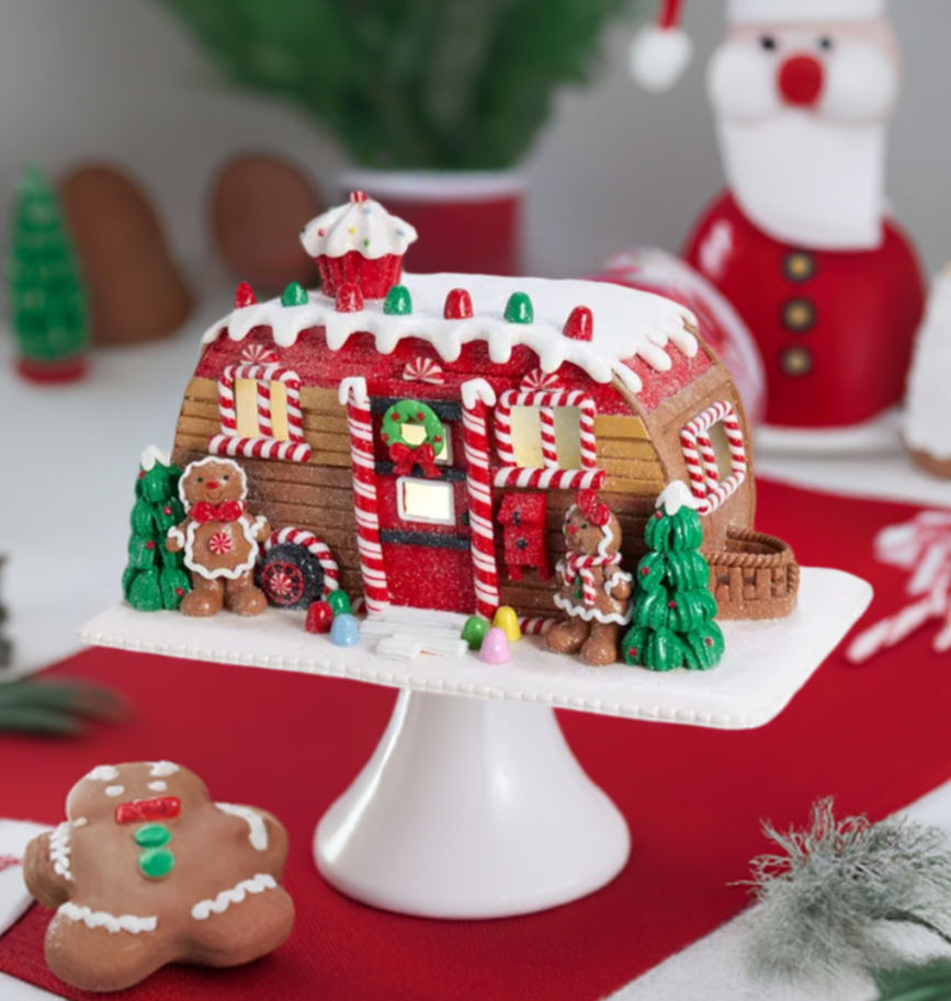 The Canton Christmas Shop 6" Gingerbread Camper LED House by Kurt Adler on pedestal with Christmas kitchen